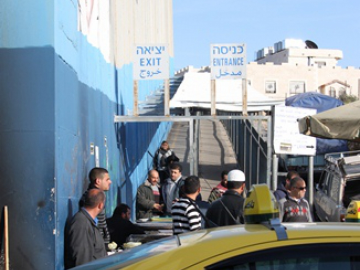 Those who are issued with permits to cross the wall for work have to start queuing at checkpoints at 3am with no guarantee that they will get to work in time. Many have reported that if they are late for work their employers send them home meaning that the whole process was a waste. Palestinians also experience a long wait on their way back from work. Generally a significant proportion of their salaries also go to their 'permit fixer'. Palestinians have been left with little other option. In this photo a lone woman can be seen returning from a day's work.