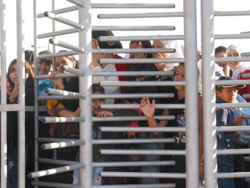Palestinians often have to wait for hours and hours to get through a checkpoint; packed together in the heat of the summer. 